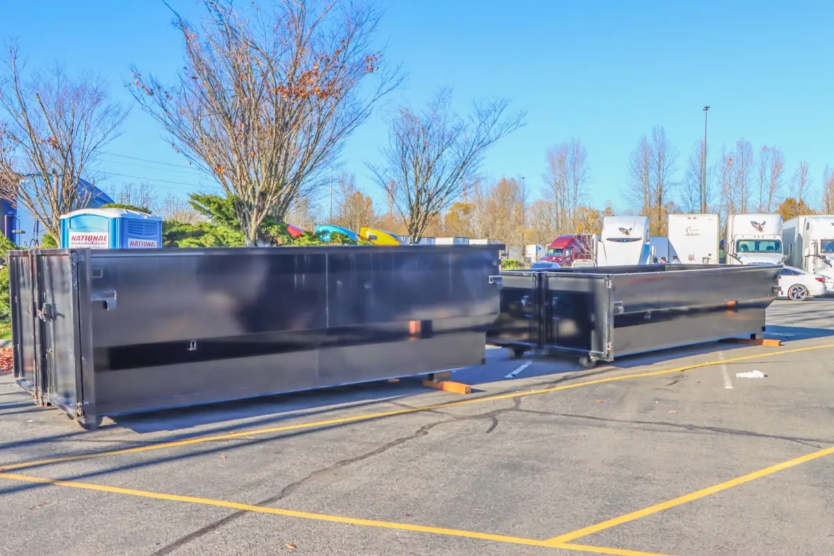 Professional dumpster rental service with roll-off container on residential driveway in Riga